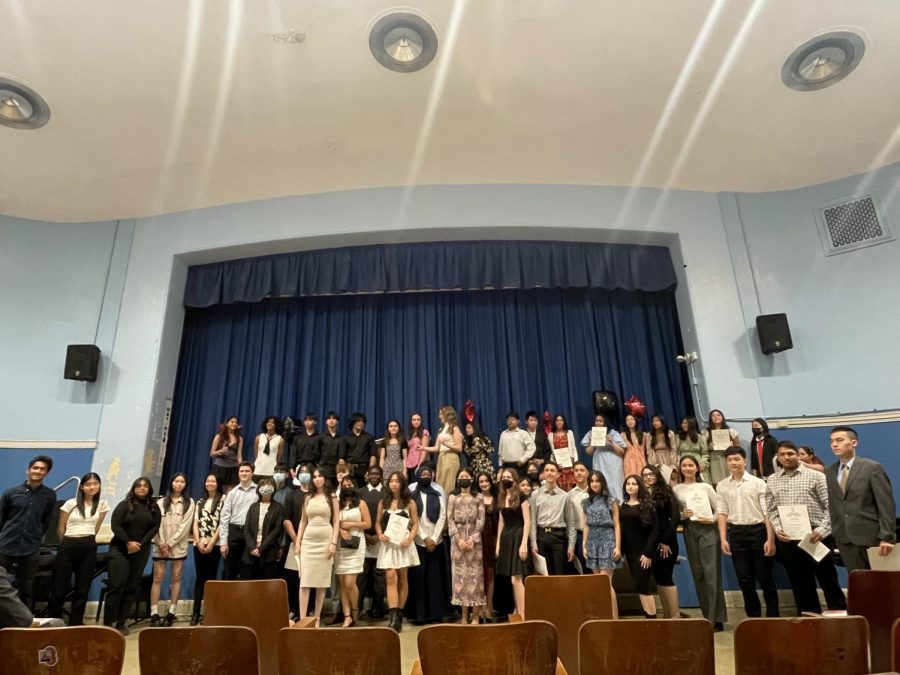 Current and new NHS members pose for a picture at the end of the ceremony