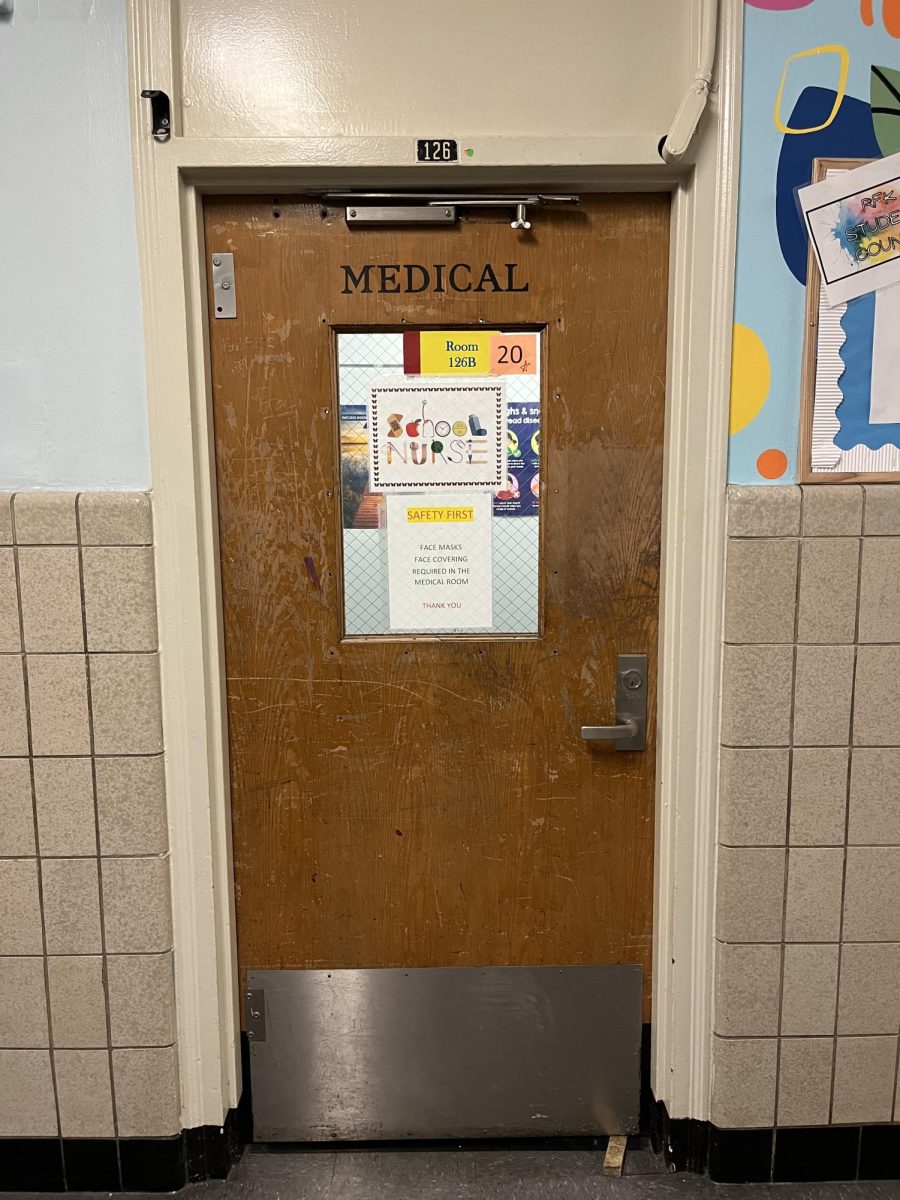 Room 126, nurse's office (door closed),  no gender neutral bathroom sign displayed.